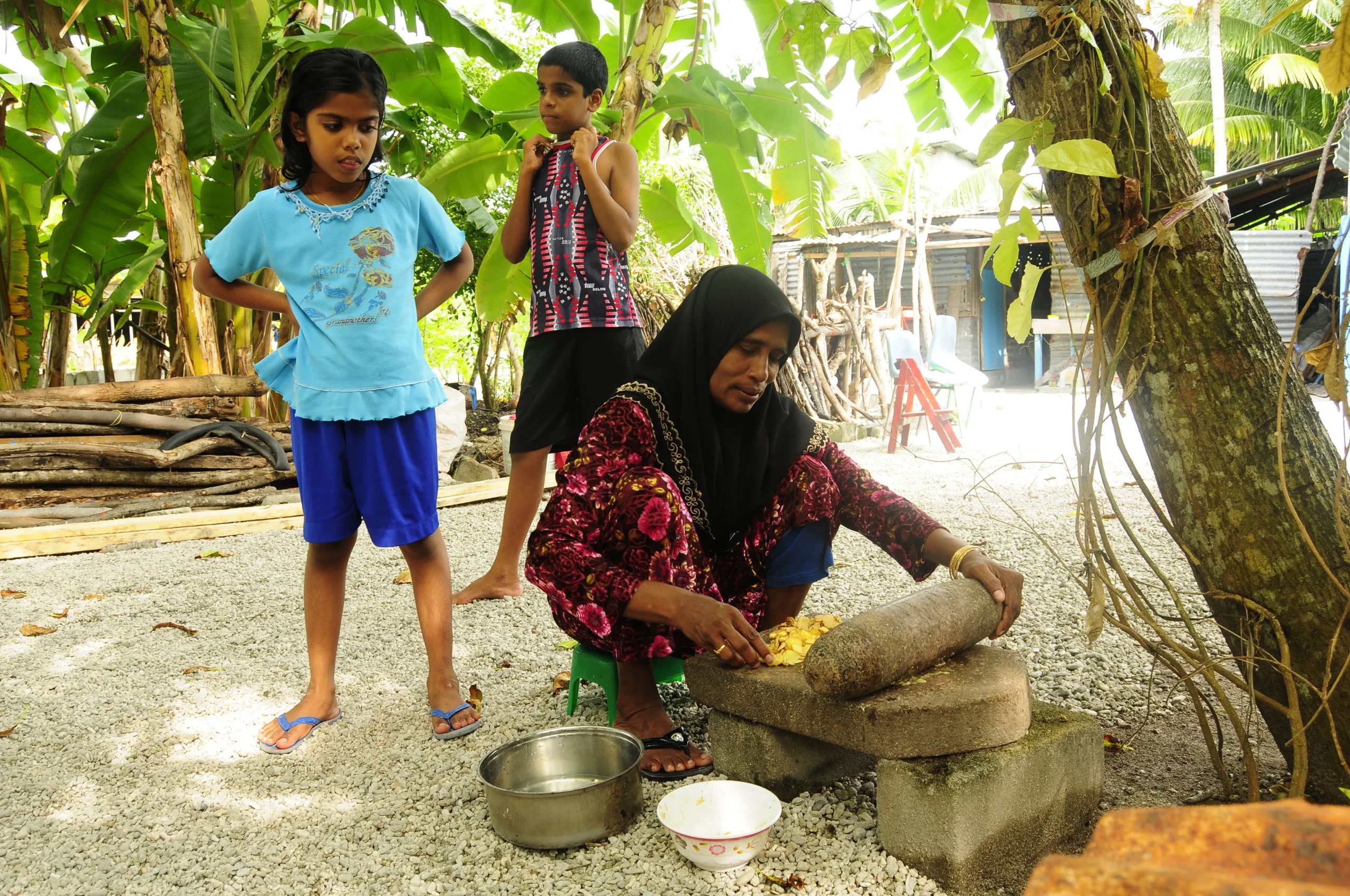 a-local-lady-turning-spice-to-a-paste-for-a-tasty-curry